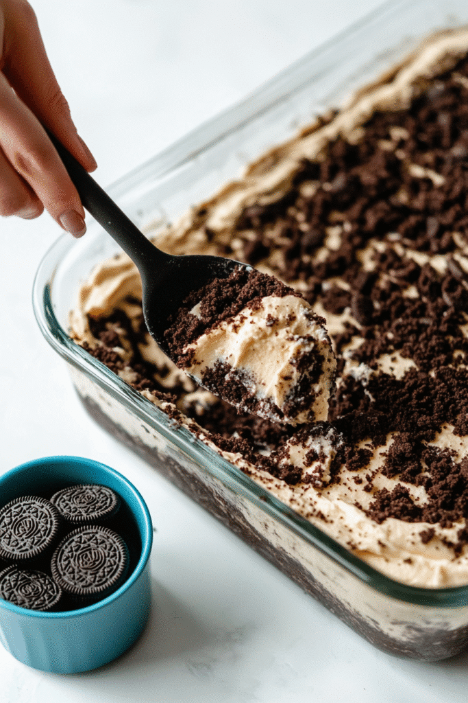 Fully assembled Oreo Lasagna in a glass dish with layers