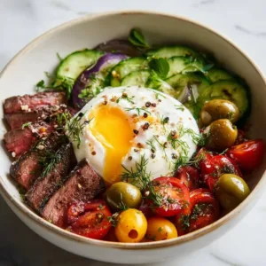 Delicious Mediterranean steak bowl with fresh vegetables and herbs