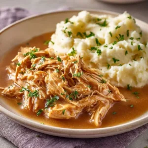 Shredded Chicken and Gravy Dinner 2 Plate of shredded chicken with rich gravy served with sides