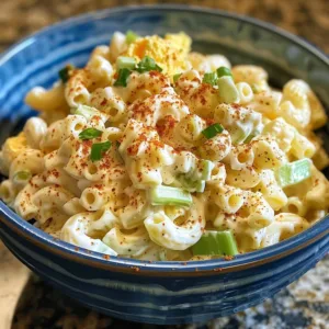 Bowl of classic macaroni salad with vegetables and dressing