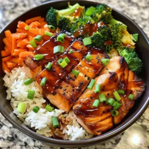 Delicious teriyaki salmon rice bowl topped with fresh vegetables