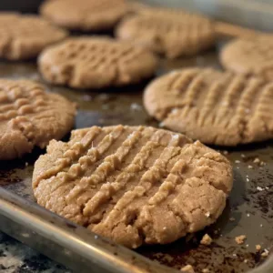 Freshly baked vegan peanut butter cookies on a cooling rack